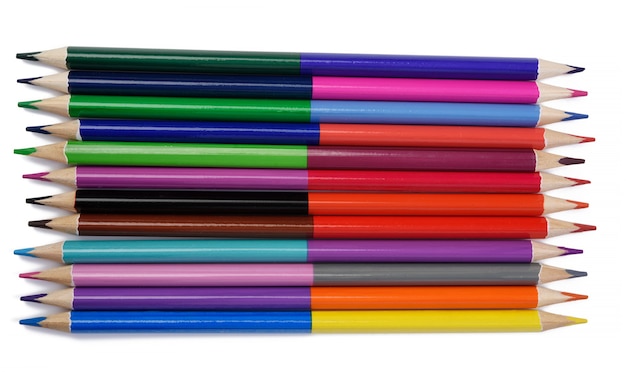 Sharpened colored wooden pencils on an white background, top view