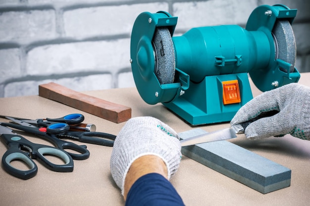 Sharpening knife with whetstone and grinder work place man sharpener