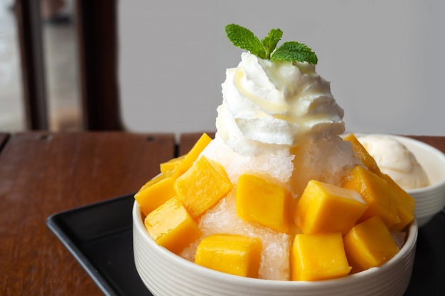 Shaved ice dessert with mango sliced.  Served with vanilla ice cream and whipped cream. 