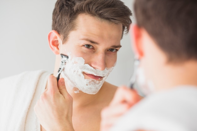 Shaving concept with attractive young man