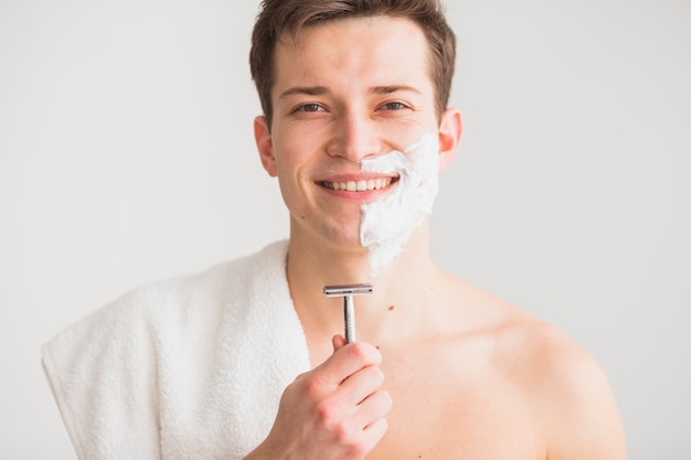 Shaving concept with attractive young man