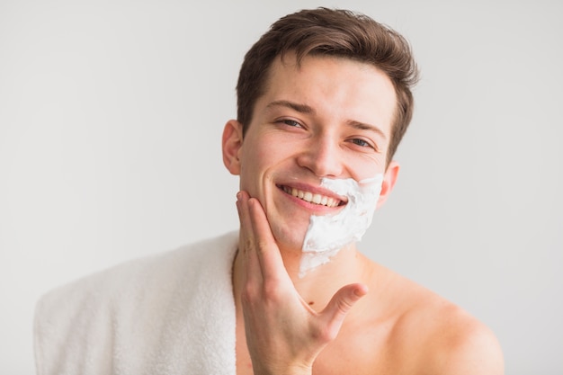 Shaving concept with attractive young man