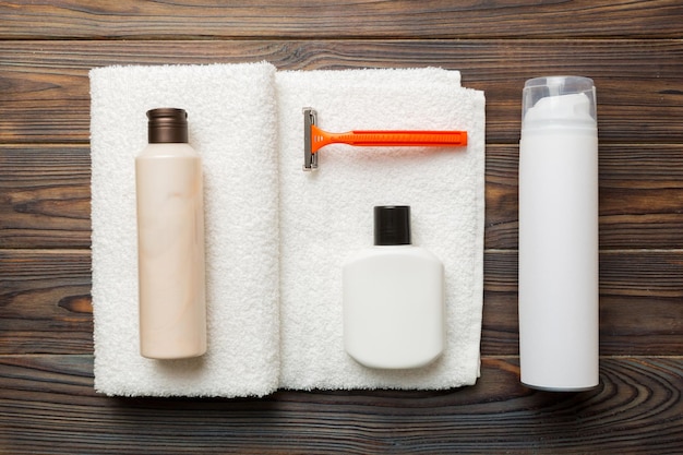 Shaving man set shaving machine towel lotion and shaving foam on colored background Men bath Accessories top view