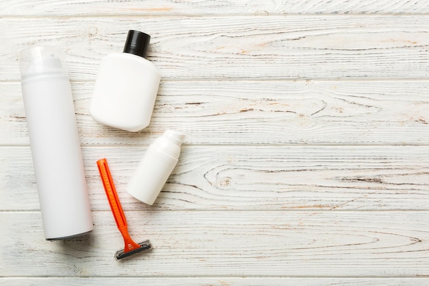 Shaving man set shaving machine towel lotion and shaving foam on colored background Men bath Accessories top view