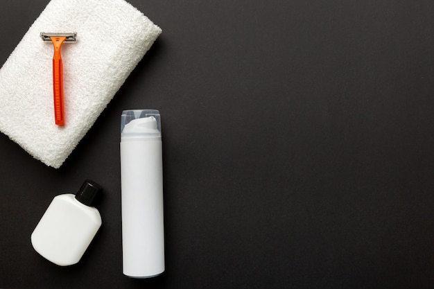 Shaving man set shaving machine towel lotion and shaving foam on colored background Men bath Accessories top view