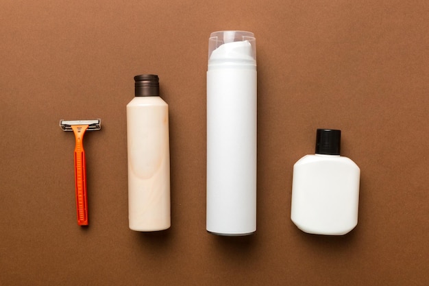 Shaving man set shaving machine towel lotion and shaving foam on colored background Men bath Accessories top view