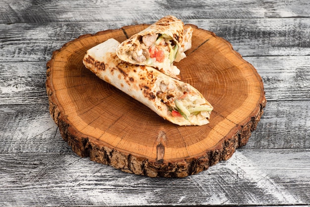 Shawarma shawarma with chicken on a wooden white background