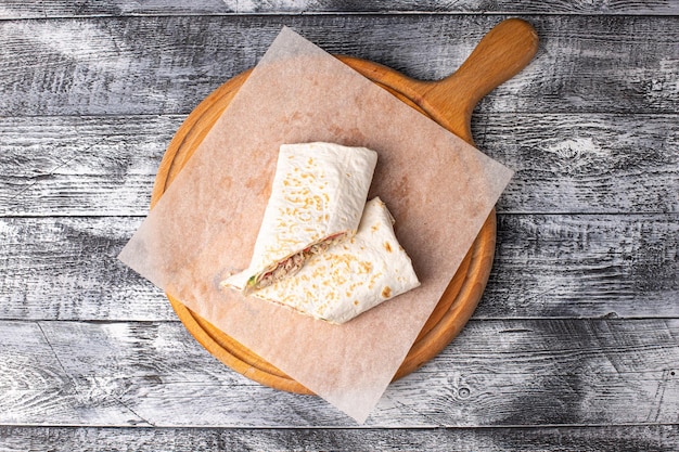 Shawarma shawarma with mushrooms corn on a white wooden background