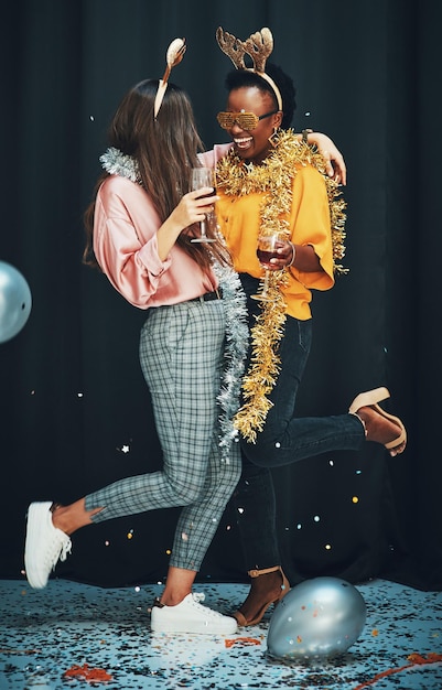 She makes life way better Full length shot of two attractive young women standing and hugging each other during a New Years party