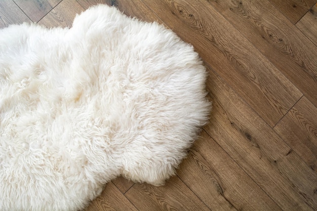 Sheep skin on the laminate floor in the room View from above