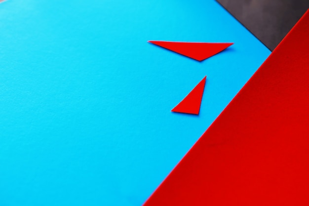 Sheets of colored paper, iridescent palette of colored paper, rainbow colors. Top view on table with colored paper and scissors.