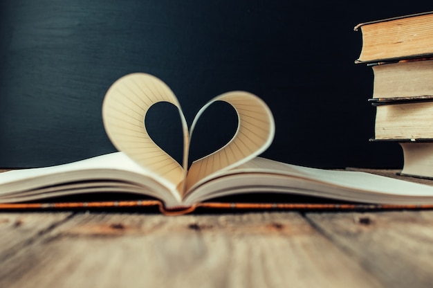 sheets of a notebook in a cage wrapped in the shape of a heart.