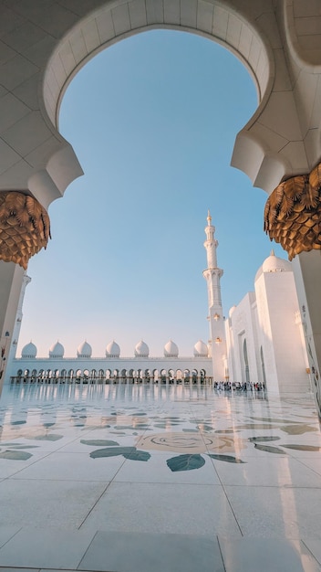 The sheikh zayed grand mosque is seen through a doorway.