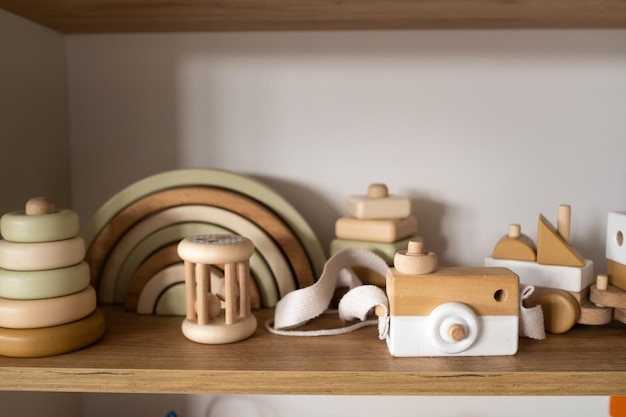 A shelf with children's wooden toys in the children's room Children's concept