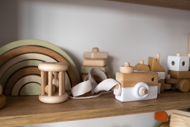 A shelf with children's wooden toys in the children's room Children's concept