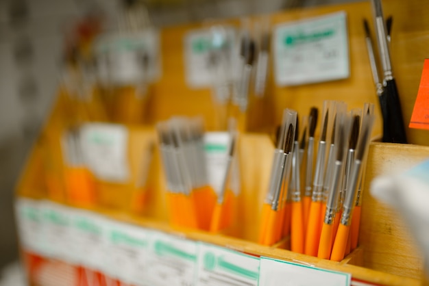 Shelf with paint brushes in stationery store