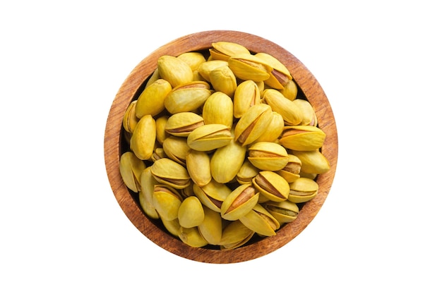 Shelled pistachios roasted nuts with saffron in wooden bowl isolated on white background Vegan food top view