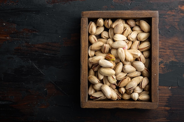 Shelled, unsalted pistachios, on old wooden table