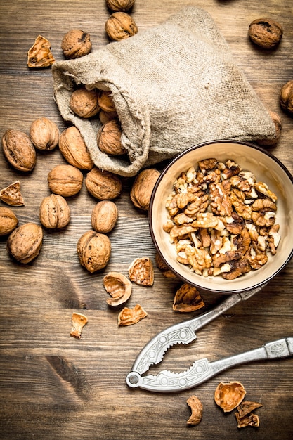 Shelled walnuts on wooden table. Top view