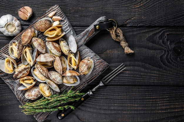 Shells Clams vongole on a wooden cutting board