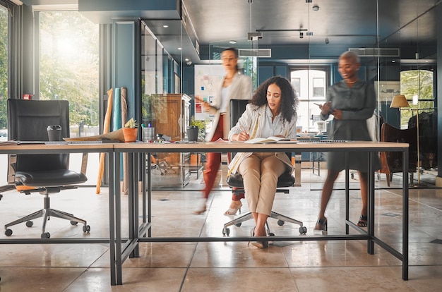 Shes not focused on anything else. Shot of a group of businesswomen working in an office.