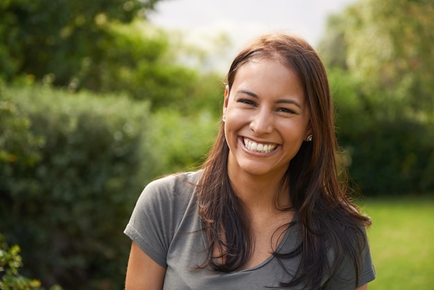 Shes a happy camper A beautiful young woman smiling outdoors