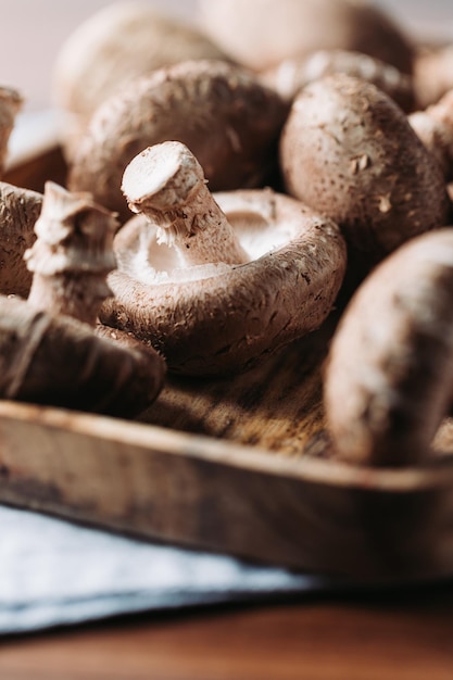 Shiitake mushrooms in a wooden bowl on a table Macro food photography