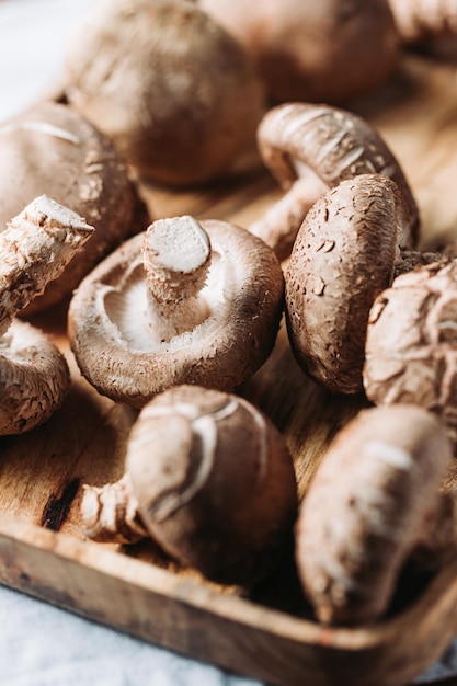 Shiitake mushrooms in a wooden bowl on a table Macro food photography