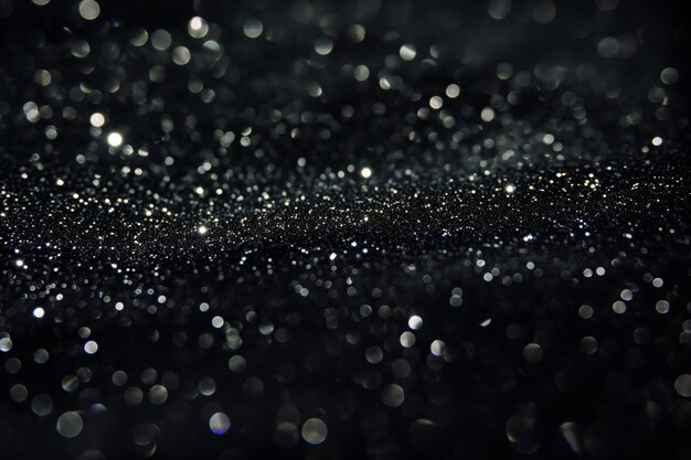 Photo a shimmering black surface covered in dew and glittering droplets