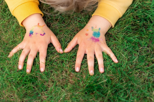 Shimmering sparkling glitter tattoo on a child's hand at a birthday party