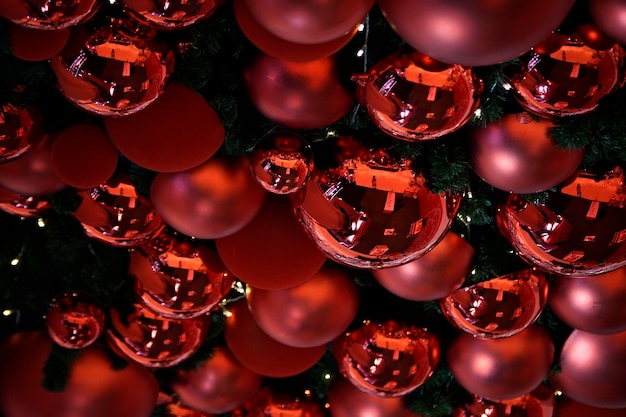 Shining red balls (in different size) are hanging on a ceiling