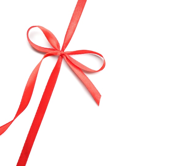 Shiny red ribbon with bow isolated on white