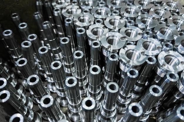 Shiny steel parts closeup background long clean steel rods after fine cnc turning