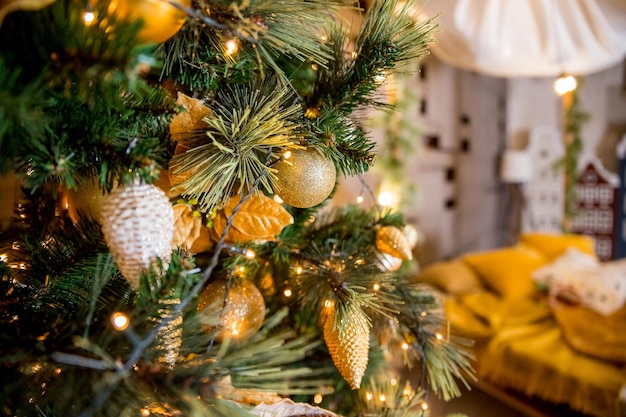 Shiny toys and garland hanging on fir brancheschristmas background with golden balls and starsShiny golden balls and garlands on New Year tree Postcard