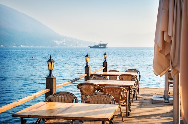 Ship and cafe tables on the beach Marmaris Turkey