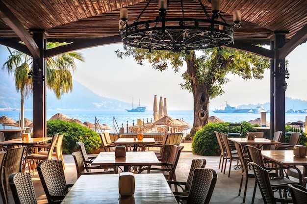 Ship and cafe tables on the beach Marmaris Turkey