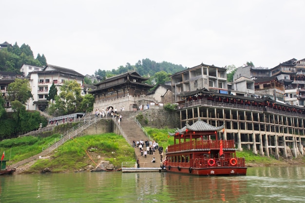 Ship cruise ferry boat tour stop at habour port Mengdong youshui river for chinese people passengers travelers travel visit in Furong Zhen Tujia ancient town at Yongshun on May 9 2024 in Hunan China