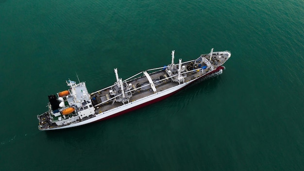 Ship floating in middle sea aerial view from drone