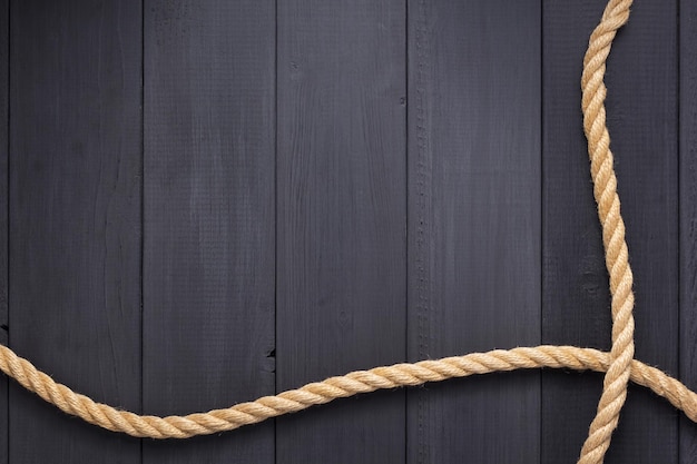 Ship rope at wooden background, plank board texture