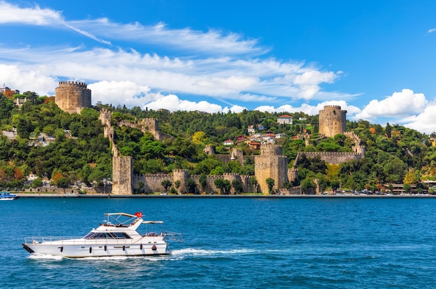 The ship sails in the Bosphorus strait by Rumeli Hisari castle Istanbul