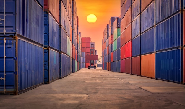 Shipping container site loading by crane in logistic port warehouse storage factory