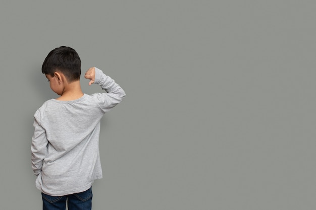 Shirt design and people concept - close up of little boy in plain tshirt front and rear isolated. Mock up template for design print