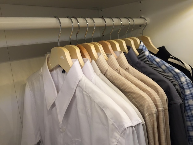 Shirts hanging on rack in closet