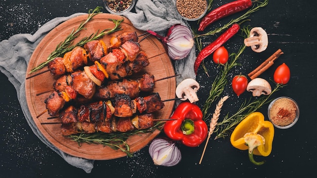 Shish kebab on skewers with onions On the black wooden table