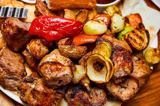 Shish kebab with grilled vegetables lavash and sauces