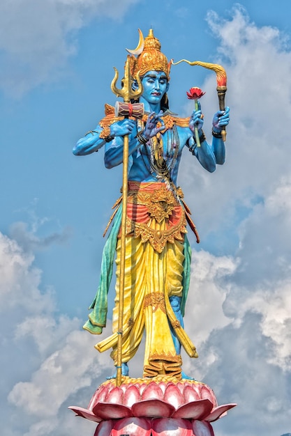 Shiva statue in the blue light sky background