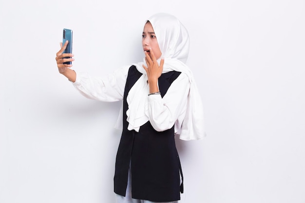 shock young asian business muslim woman using mobile phone isolated on white background