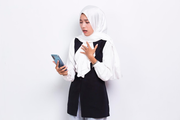 shock young asian business muslim woman using mobile phone isolated on white background