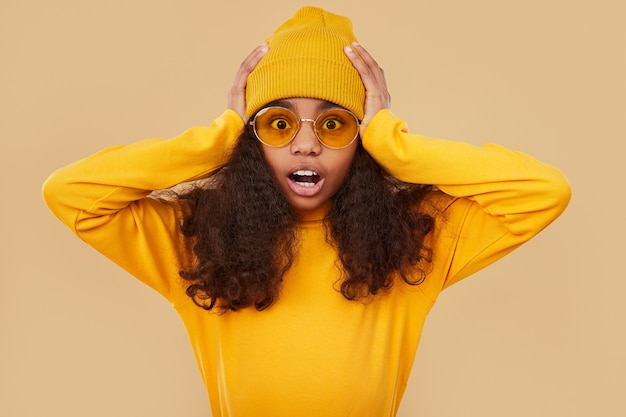 Shocked african girl looking at camera