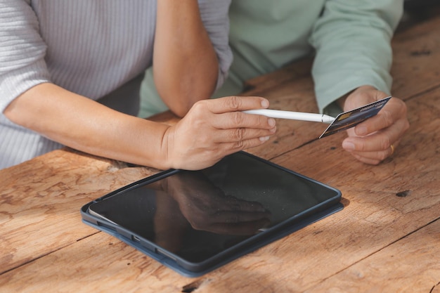 Shocked aged couple become victims of online fraud using credit card phone to pay for goods order service online on suspicious website Frustrated older spouses overspending money at internet shopping